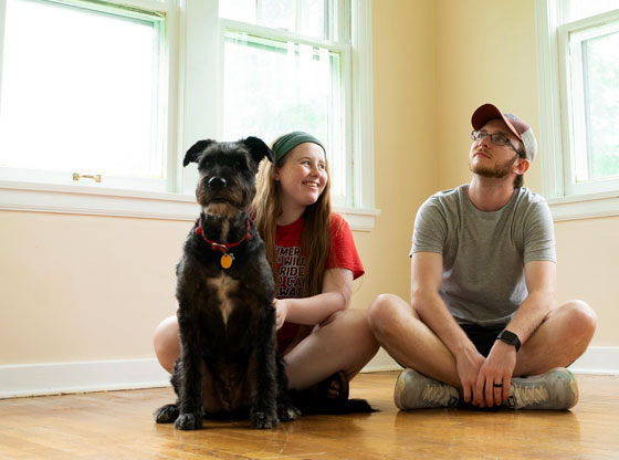 First-time home buyers sitting in new home.