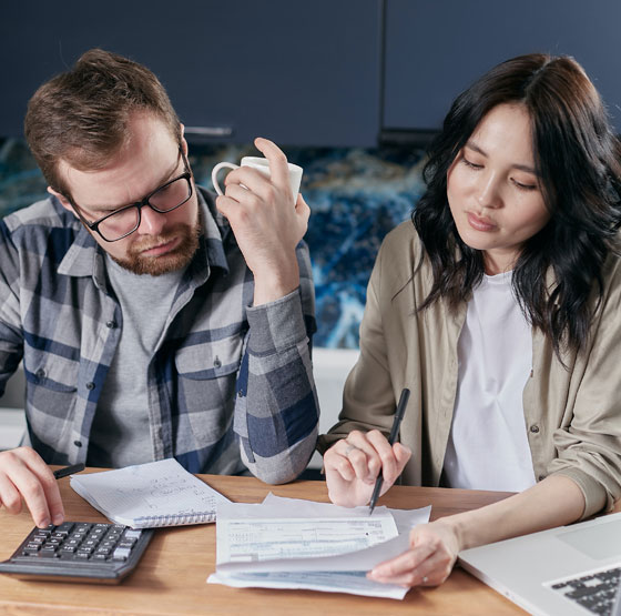 Couple looking at their finances to save for a downpayment on a home.